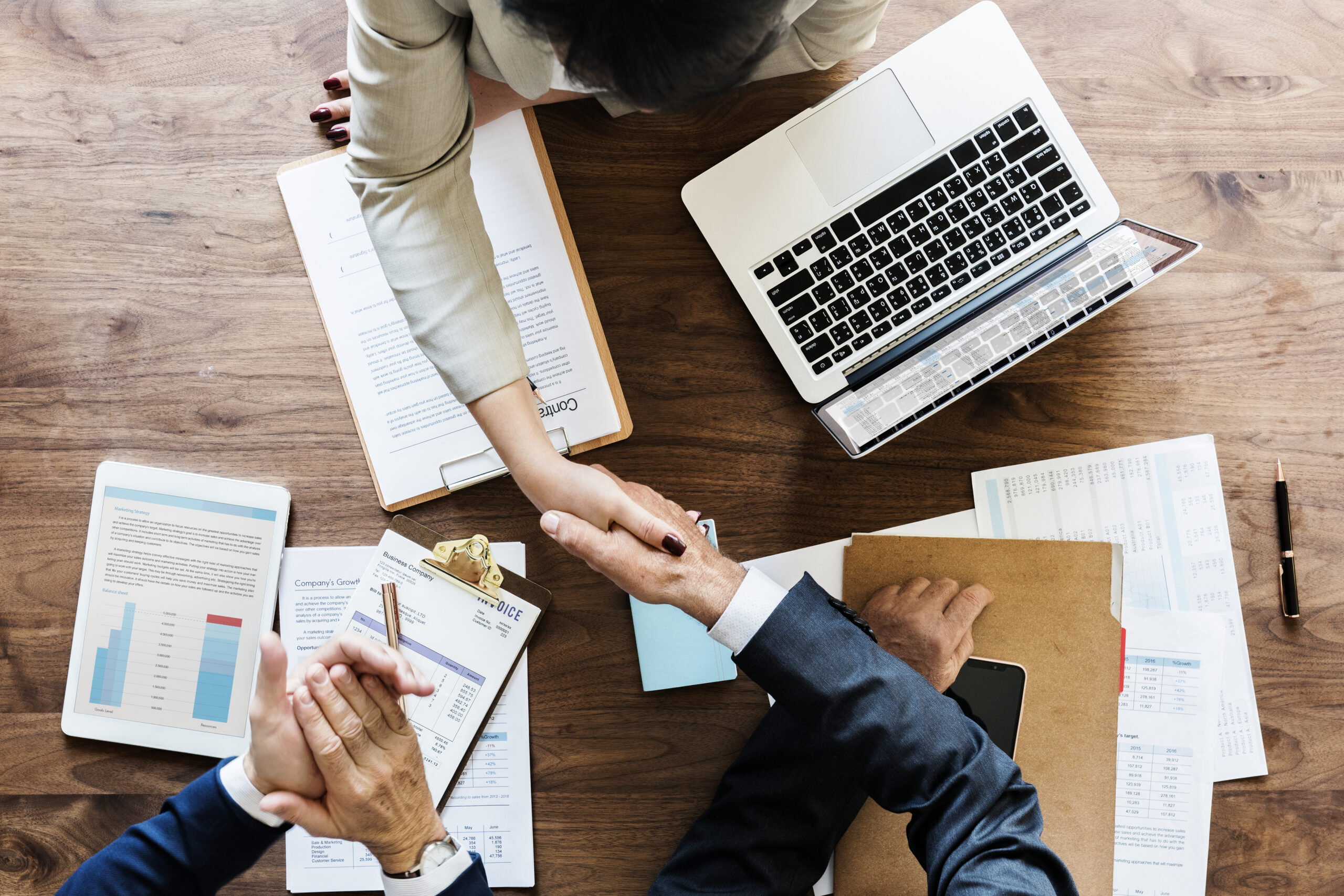 Business people shaking hands together