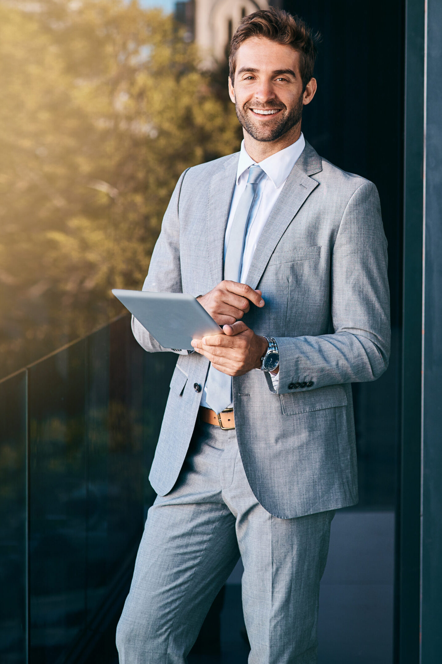 corporate-smile-portrait-businessman-with-tablet-networking-reading-email-news-lens-flare-professional-person-with-technology-information-browsing-internet-social-media